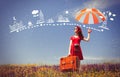 Girl in red dress with umbrella and suitcase Royalty Free Stock Photo