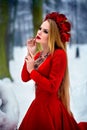 Girl in red dress in winter forest