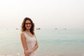 Girl in red glasses on the coast on a cloudy day Vacation by the sea. Summer, outdoors. Beach landscape Royalty Free Stock Photo