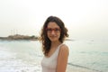 Girl in red glasses on the coast on a cloudy day Vacation by the sea. Summer, outdoors. Beach landscape Royalty Free Stock Photo