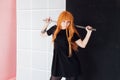 Girl cosplayer with red hair anime japan sword Royalty Free Stock Photo