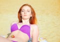 girl with red hair and bikini posing at the beach Royalty Free Stock Photo