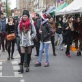 Girl in red hair dressed in cool Londoner style walking in Brick lane, a street popular among young trendy people Royalty Free Stock Photo