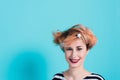 Girl with red hair laughing holding his head. Tangled hair. positive emotions. Studio shot.