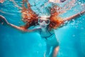 Girl with red hair pose underwater in scuba mask Royalty Free Stock Photo