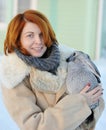 Girl with red hair in a sheepskin coat with rabbit Royalty Free Stock Photo