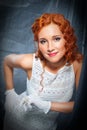 Girl with red hair wearing white dress and gloves