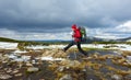 A girl in a red hat jumps over bumps among the water on a snowy Royalty Free Stock Photo