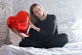 a girl with red heart-shaped balloons smiles and enjoys life. Caucasian woman celebrating valentine& x27;s day. A note to Royalty Free Stock Photo