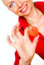 Girl in red holding strawberry slice Royalty Free Stock Photo
