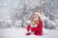 A large labrador dog and a cat in winter on a walk with a young woman in a snowy field Royalty Free Stock Photo