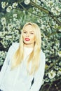 Girl with red lips and blonde hair in blossom Royalty Free Stock Photo