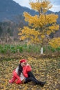 The girl in red overlie with ginkgo leaf Royalty Free Stock Photo