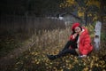 The girl in red overlie with ginkgo leaf Royalty Free Stock Photo