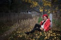 The girl in red overlie with ginkgo leaf