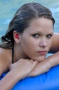 Girl with red plastic ear protection in the pool Royalty Free Stock Photo