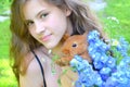 Girl with the red rabbit and bouquet with delphinium blue and Royalty Free Stock Photo