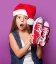 Girl in red Santas hat with gumshoes