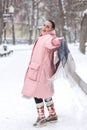 a girl in a red scarf walks in a winter park Royalty Free Stock Photo