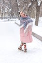 a girl in a red scarf walks in a winter park Royalty Free Stock Photo