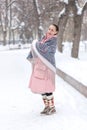 a girl in a red scarf walks in a winter park Royalty Free Stock Photo