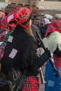 Girl with Red Scottish Kerchief and Shawl Playing Flute Instrument