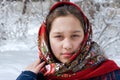 The girl in red shawls against the backdrop of a winter landscape.