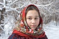 The girl in red shawls against the backdrop of a winter landscape.