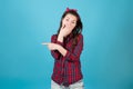 Girl in a red shirt laughs, covering her mouth and points a finger to the side Royalty Free Stock Photo