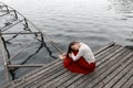 Lonely european girl in red skirt on the bridge