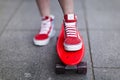 Girl in red sneakers put her foot on a skateboard Royalty Free Stock Photo