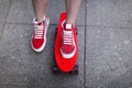 Girl in red sneakers put her foot on a skateboard Royalty Free Stock Photo