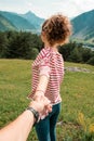 Happy attractive woman hiker standing and holding someone by hand with beautiful landscape of mountains hill Royalty Free Stock Photo