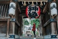 Girl in red suit in front of Kushida Shrine