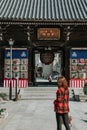 Girl in red suit in front of Kushida Shrine