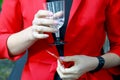 Girl in a red suit holds a glass of champagne Royalty Free Stock Photo