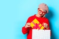 Girl in red sweater with gift box and shopping bag Royalty Free Stock Photo