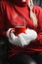 Girl in red sweater and white mittens holding cup Royalty Free Stock Photo