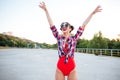 Girl in red swimsuit posing with hands up outdoors Royalty Free Stock Photo