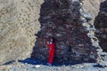 Girl in a red tracksuit takes a selfie in the shadow of an old ruined stone wall Royalty Free Stock Photo