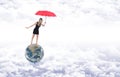 Girl with red umbrella on planet earth represented as a balloon Royalty Free Stock Photo