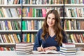 Girl reding books in the library, studying