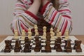 The girl reflects on the first chess move