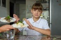 The girl refuses to eat and looks sadly into the frame