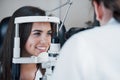 Girl rejoices that she will not have to wear glasses. Optometrist checking vision of young beautiful woman Royalty Free Stock Photo