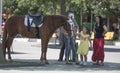 Girl with relatives thanks for horse riding