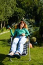 Girl relax in chaise longue on garden