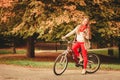 Girl relaxing in autumnal park with bicycle. Royalty Free Stock Photo