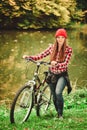 Girl relaxing in autumnal park with bicycle. Royalty Free Stock Photo