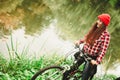 Girl relaxing in autumnal park with bicycle. Royalty Free Stock Photo